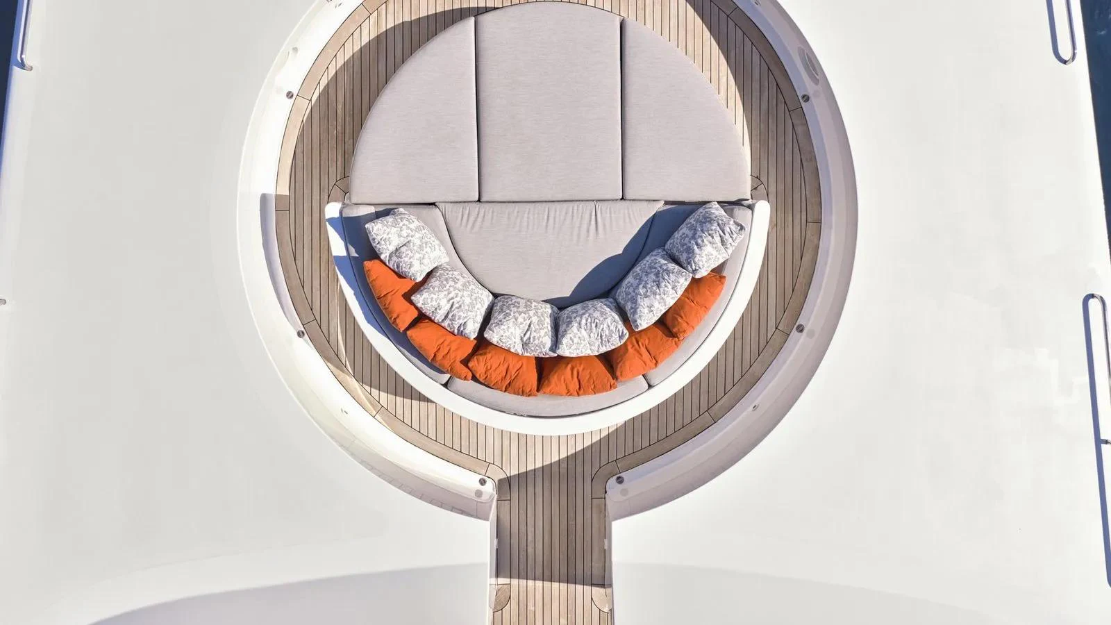 The sundeck features a stylish circular lounging area with plush cushions and a wooden deck. aboard THEOLINA Yacht for Sale