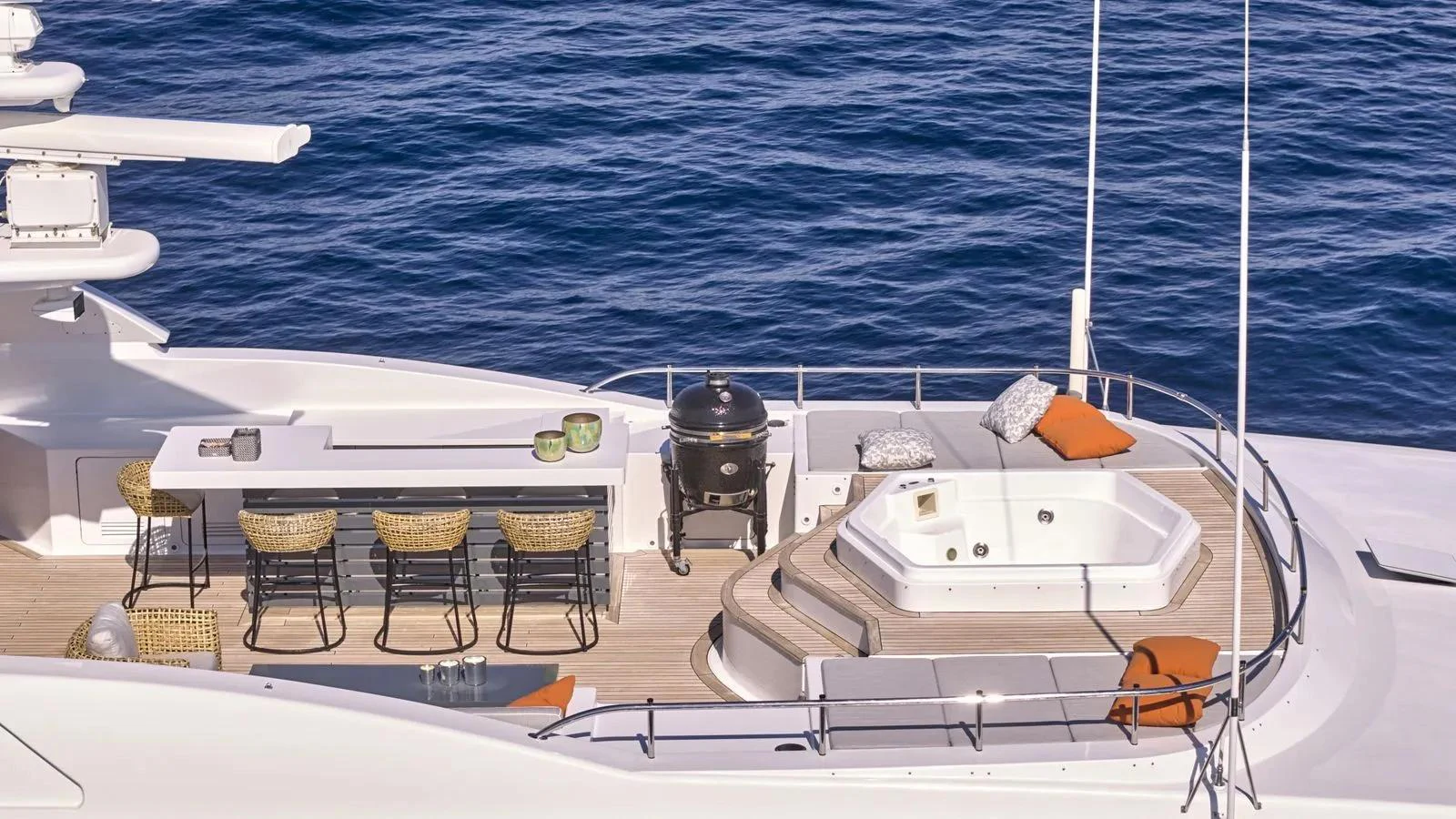 The sundeck features a luxurious hot tub, a stylish bar area, and comfortable seating with stunning ocean views. aboard THEOLINA Yacht for Sale