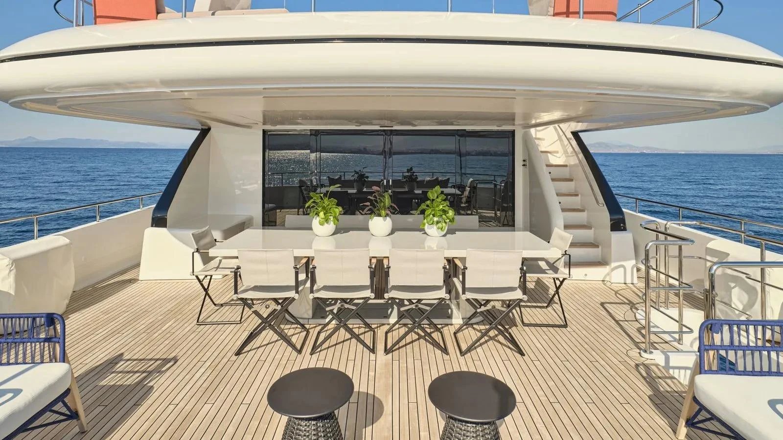 The aft deck features a spacious dining area with elegant seating and panoramic ocean views. aboard THEOLINA Yacht for Sale