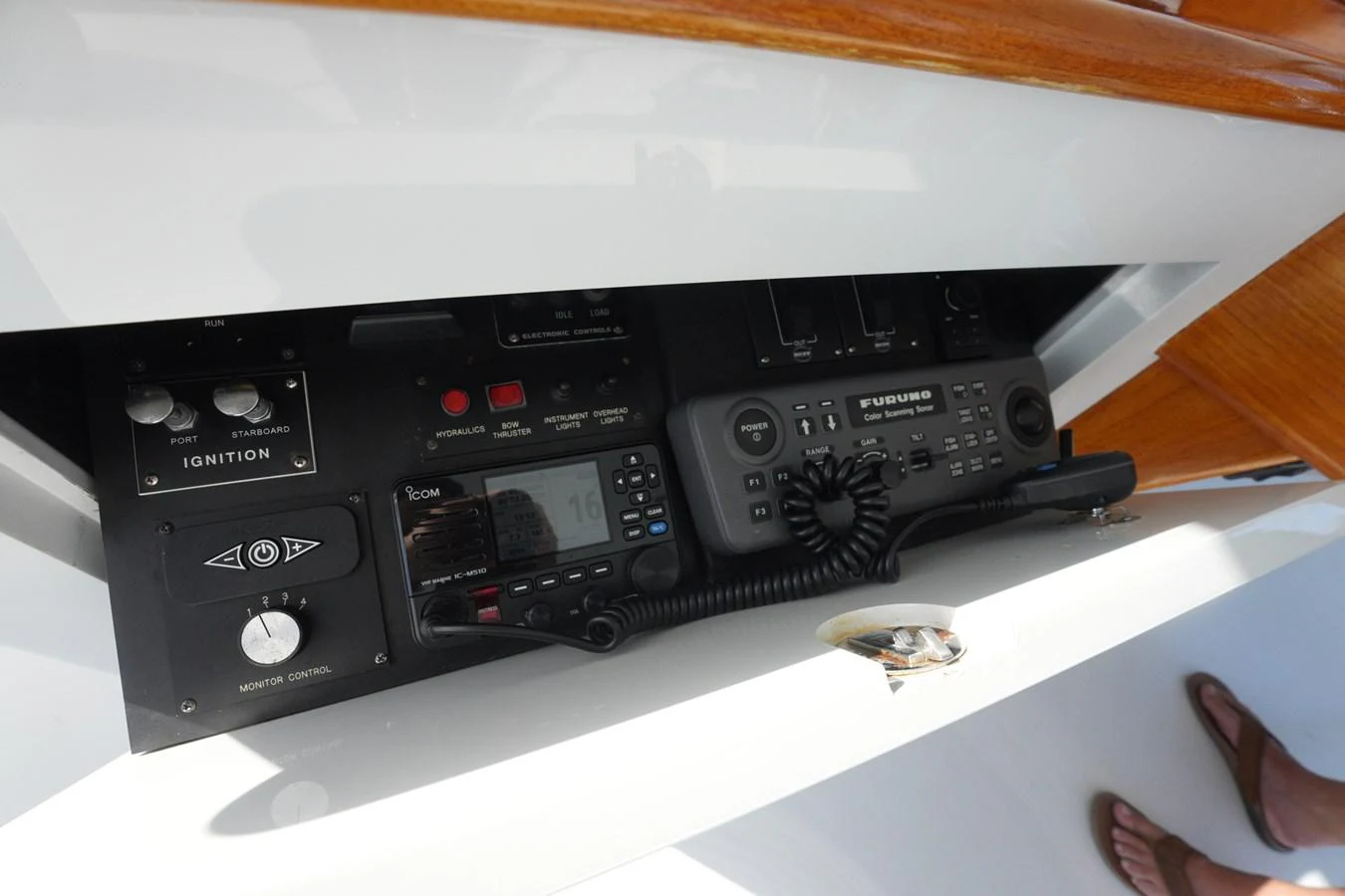 A close-up view of the yacht's helm electronics, showcasing the ignition and communication systems. aboard WISH YOU WERE HERE Yacht for Sale