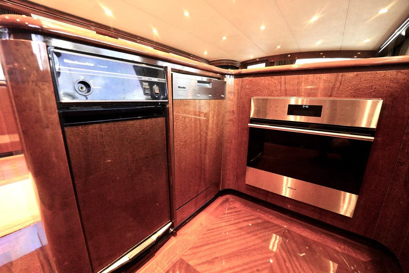 The galley features modern appliances and rich wood finishes, creating a warm and functional space. aboard WISH YOU WERE HERE Yacht for Sale