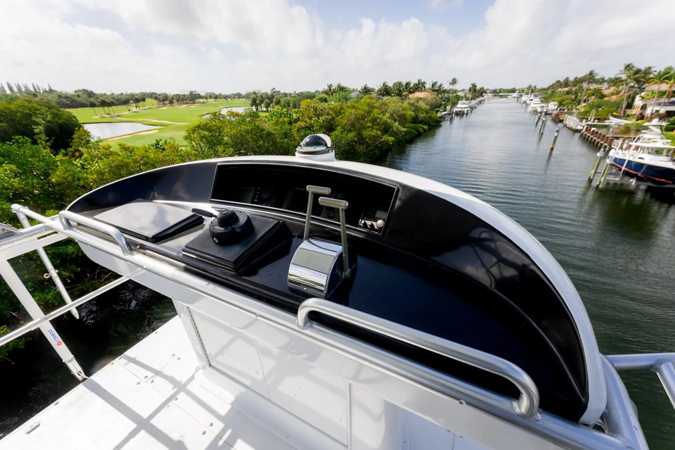 The helm station offers a commanding view of the surrounding waterways and lush greenery. aboard WISH YOU WERE HERE Yacht for Sale