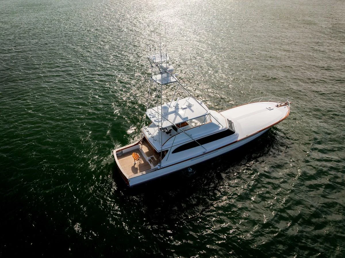 A sleek yacht glides gracefully on the open water, showcasing its elegant design and spacious deck. aboard WISH YOU WERE HERE Yacht for Sale