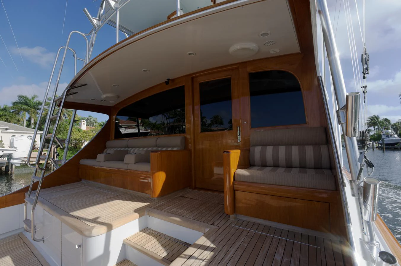 The aft deck features comfortable seating and elegant wooden finishes, perfect for relaxation and socializing. aboard WISH YOU WERE HERE Yacht for Sale