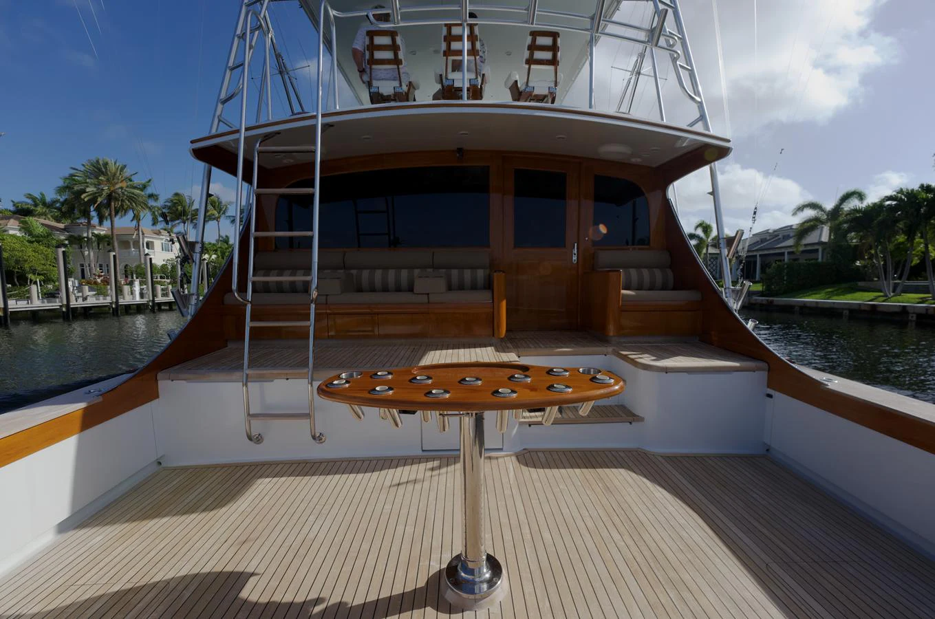 The yacht's aft deck features a spacious seating area and a fishing rod holder, perfect for outdoor relaxation and activities. aboard WISH YOU WERE HERE Yacht for Sale