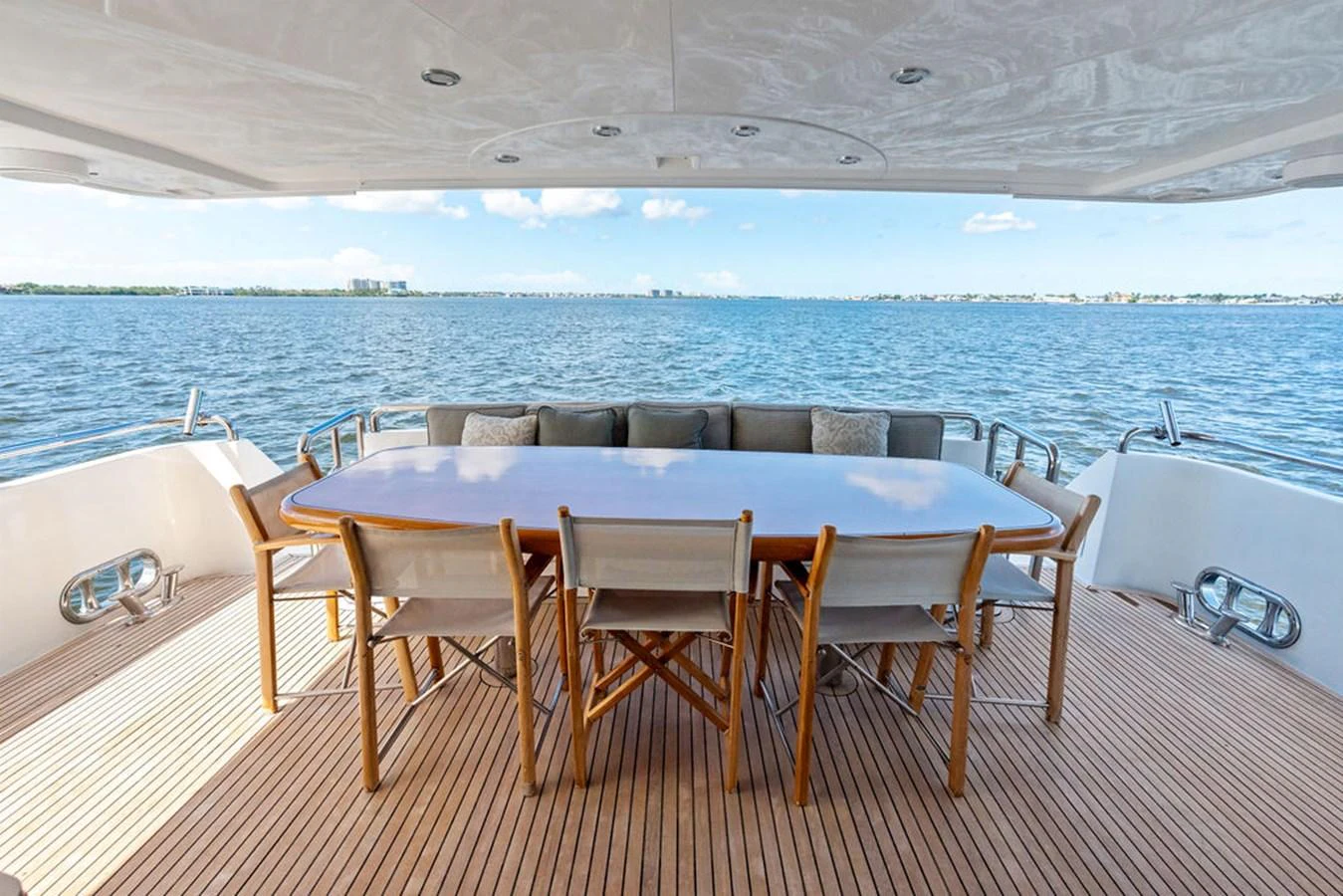 The aft deck features a spacious dining area with a stunning view of the water. aboard BABE Yacht for Sale