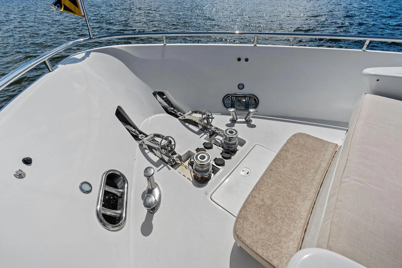 The yacht's bow features a well-maintained anchor system and a comfortable seating area. aboard BABE Yacht for Sale