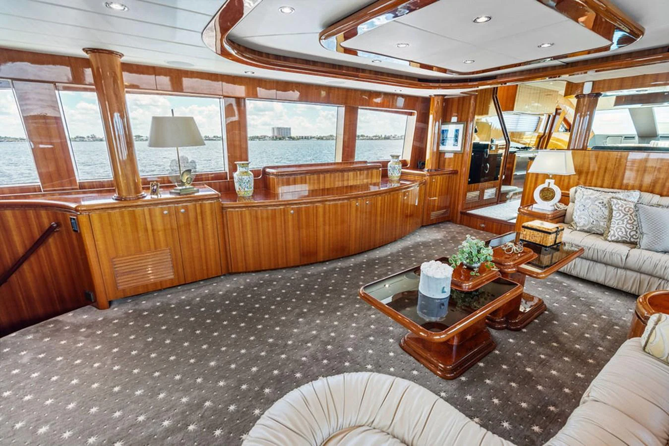 The yacht's salon features luxurious wood paneling, plush seating, and expansive windows offering stunning views. aboard BABE Yacht for Sale