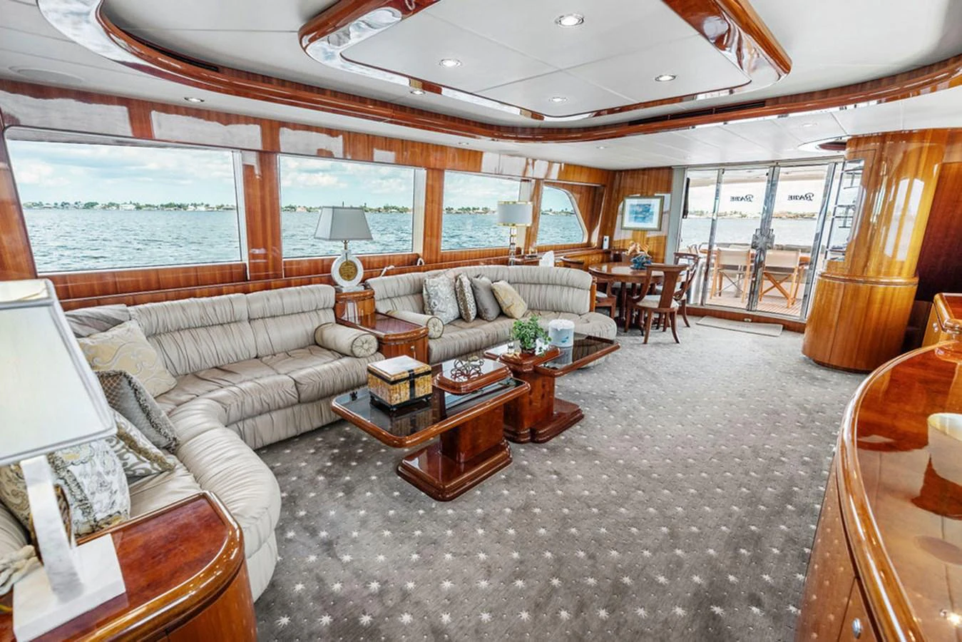 The salon features luxurious seating with panoramic windows offering stunning views. aboard BABE Yacht for Sale