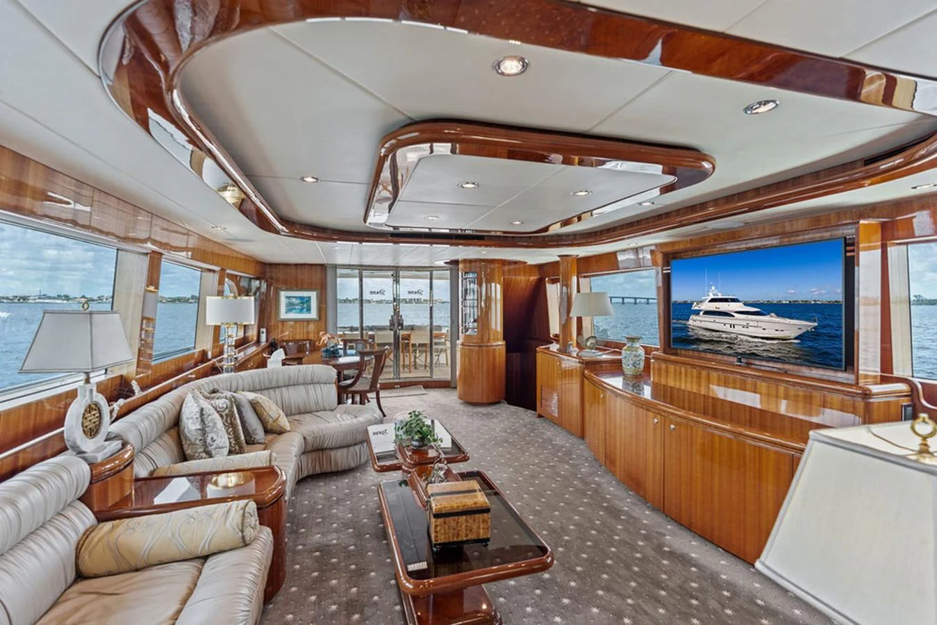 The yacht's salon features luxurious seating, elegant wood finishes, and large windows offering stunning views. aboard BABE Yacht for Sale