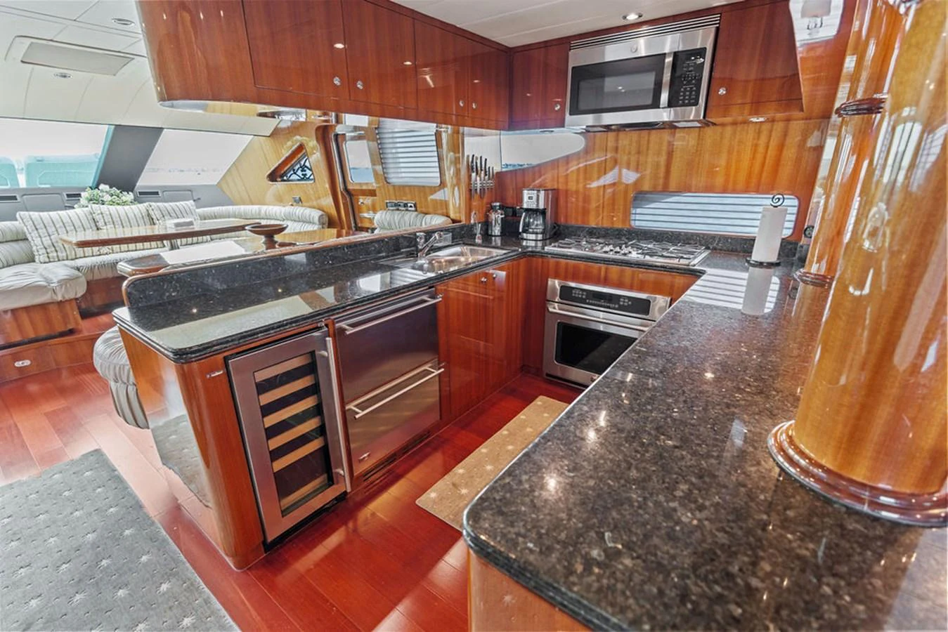 The yacht's galley features high-end appliances and luxurious wood finishes, creating a warm and inviting space for culinary activities. aboard BABE Yacht for Sale