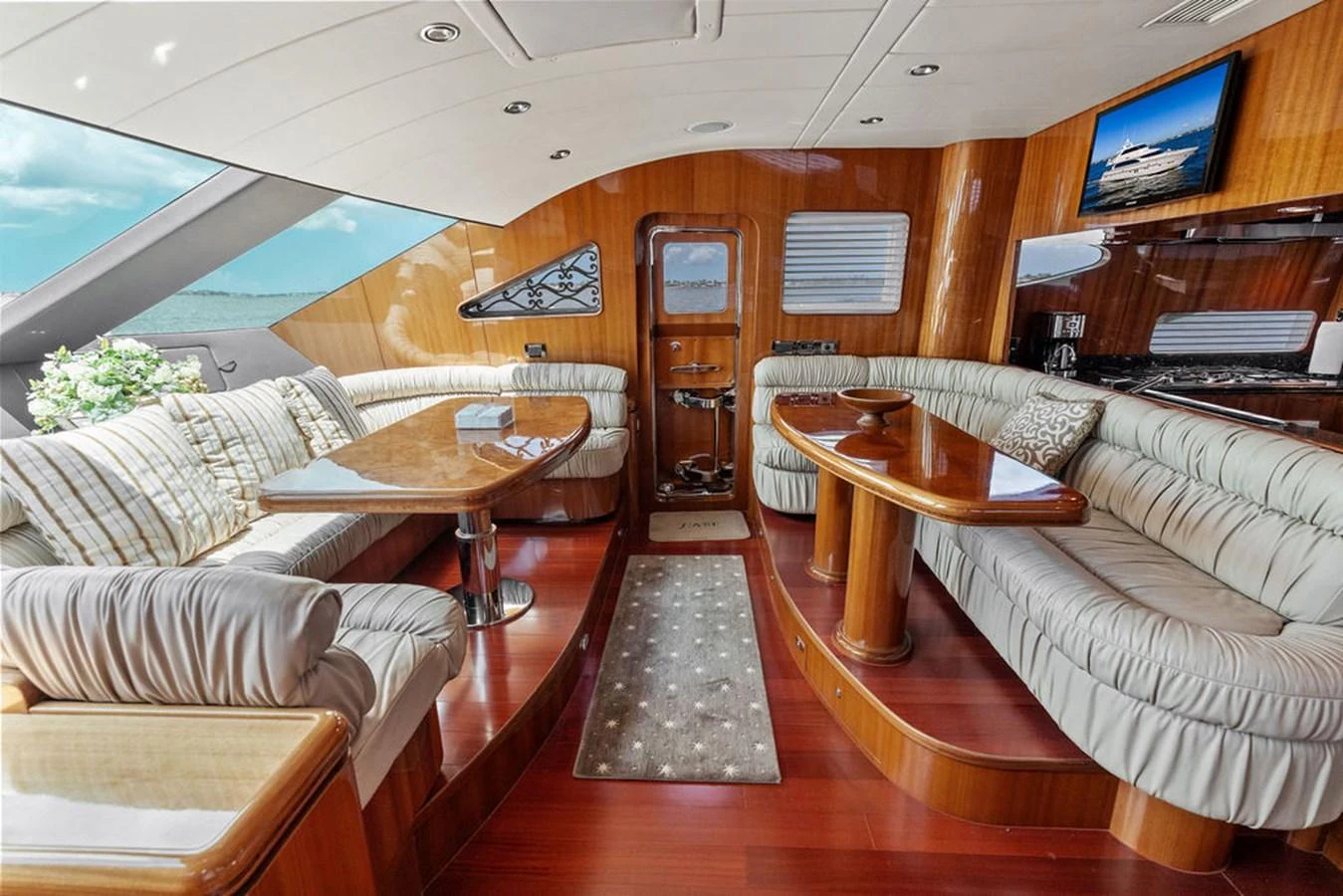 The saloon offers a spacious and luxurious seating area with elegant wooden finishes and ample natural light. aboard BABE Yacht for Sale