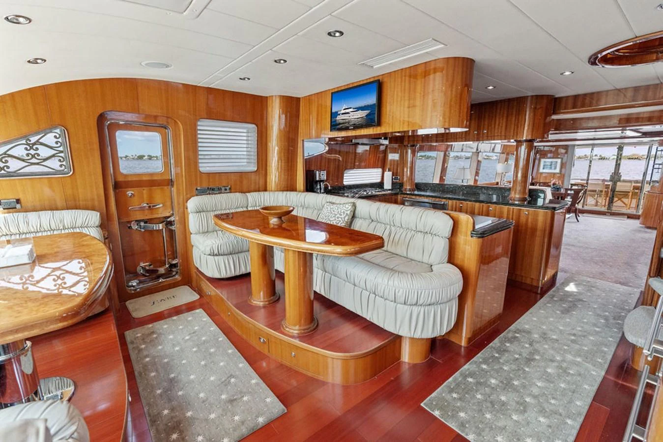 The salon features elegant wood finishes, plush seating, and a spacious layout for relaxation and entertainment. aboard BABE Yacht for Sale