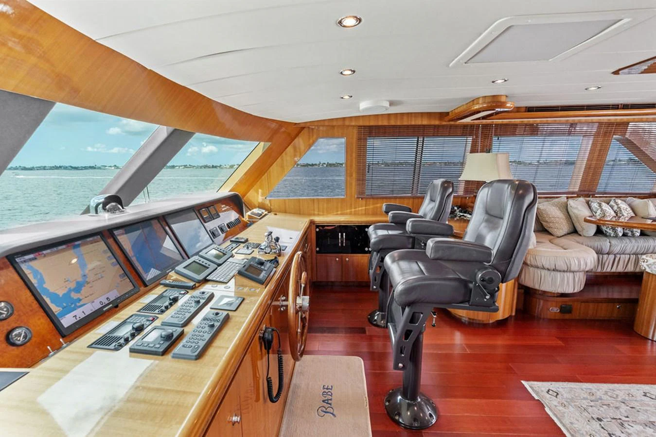 The helm station offers a commanding view with luxurious seating and advanced navigation equipment. aboard BABE Yacht for Sale