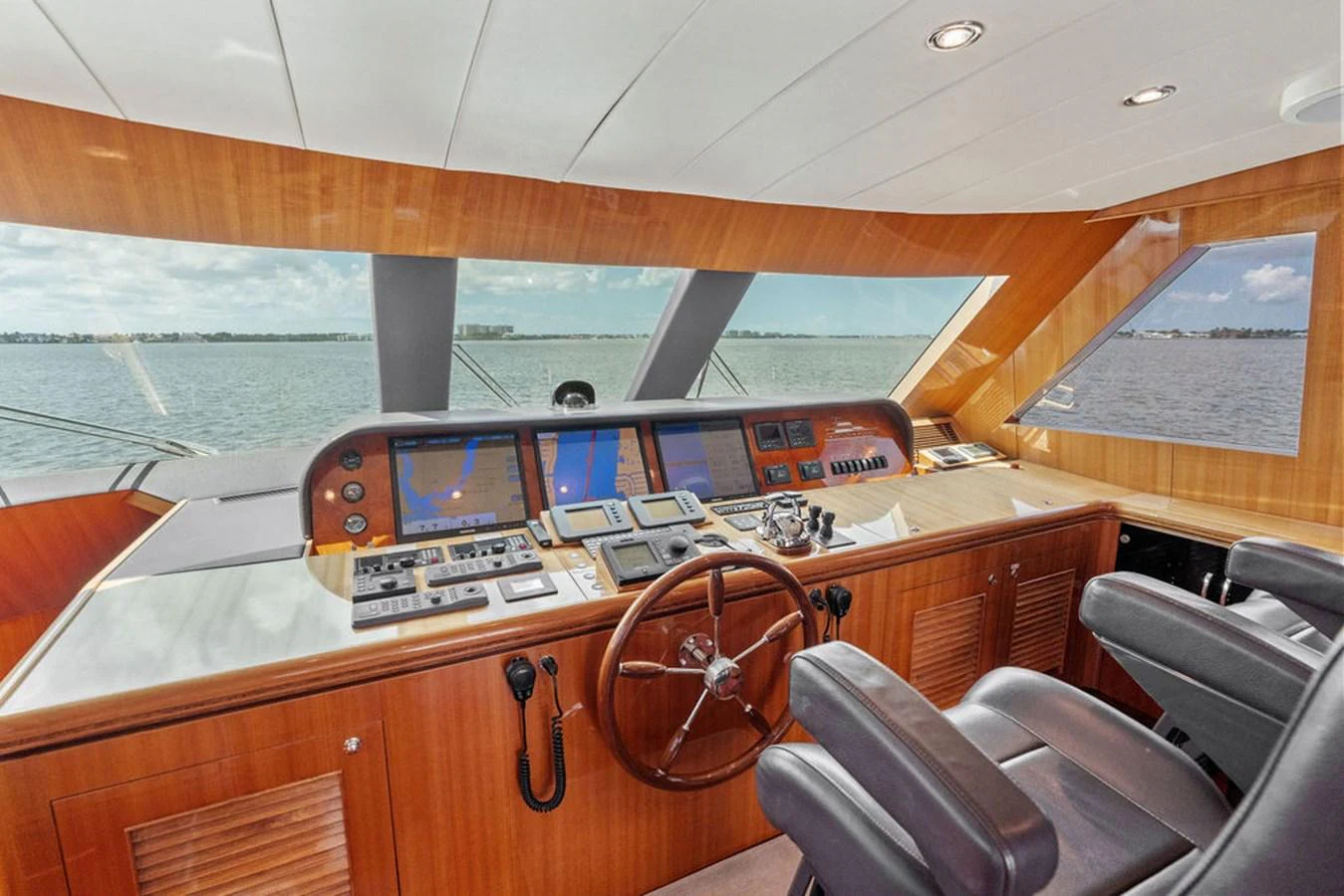 The helm station offers a commanding view with state-of-the-art navigation equipment and luxurious wood finishes. aboard BABE Yacht for Sale