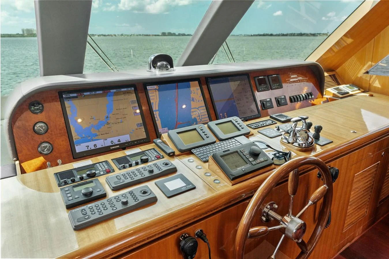 The helm station features advanced navigation equipment and a classic wooden steering wheel, offering a commanding view of the sea. aboard BABE Yacht for Sale