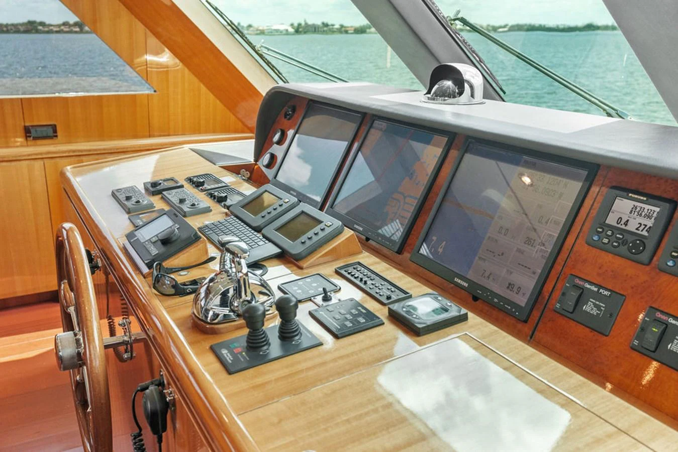 The helm station features advanced navigation equipment and luxurious wooden finishes. aboard BABE Yacht for Sale