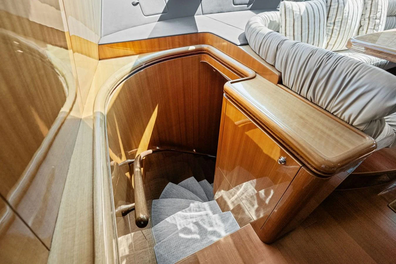 A beautifully crafted wooden staircase leads to the lower deck, showcasing the yacht's elegant interior design. aboard BABE Yacht for Sale