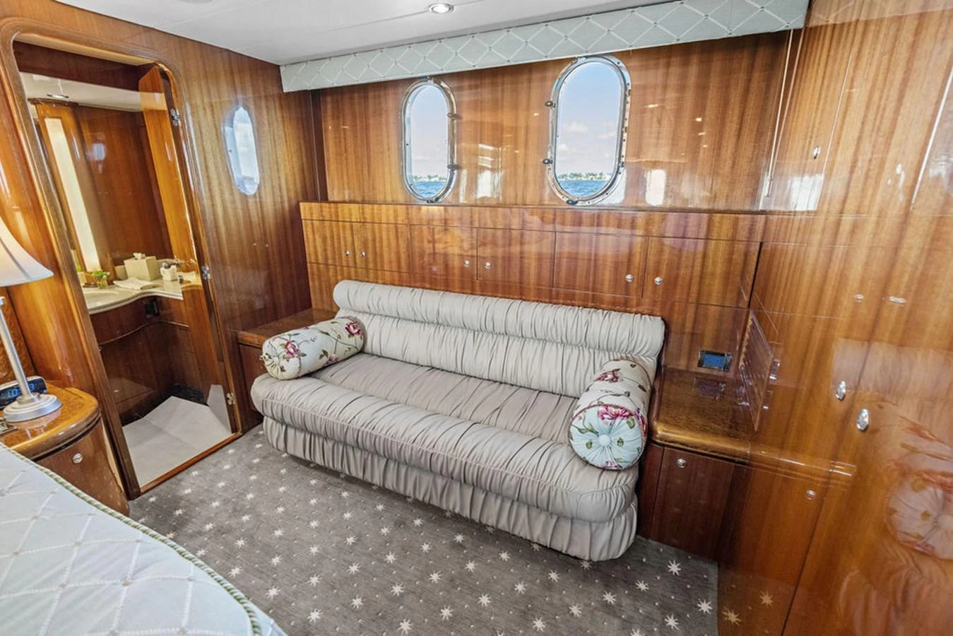 The stateroom features a plush sofa and elegant wood paneling, creating a cozy and inviting atmosphere. aboard BABE Yacht for Sale