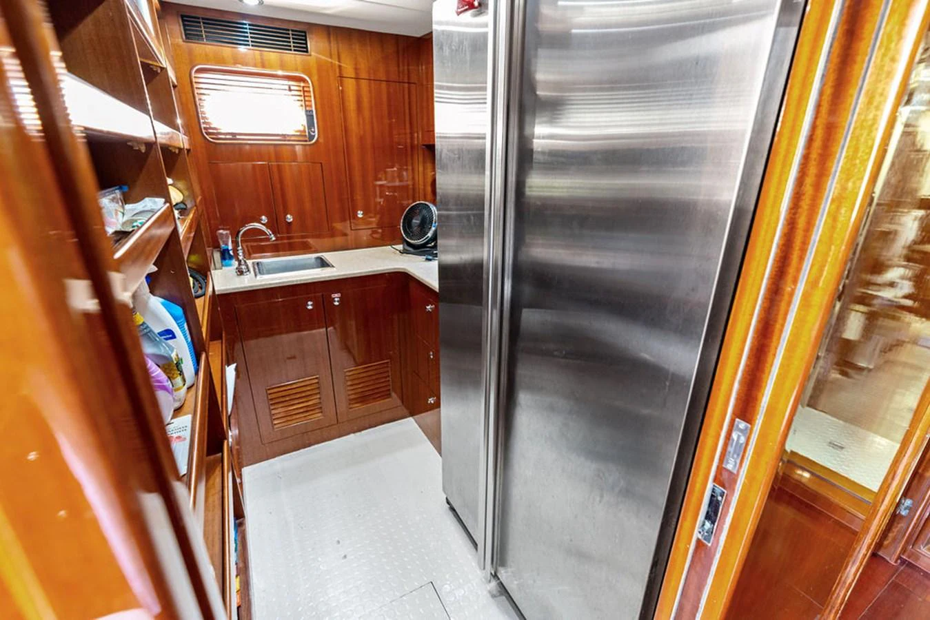 The yacht's galley features modern stainless steel appliances and rich wooden cabinetry. aboard BABE Yacht for Sale