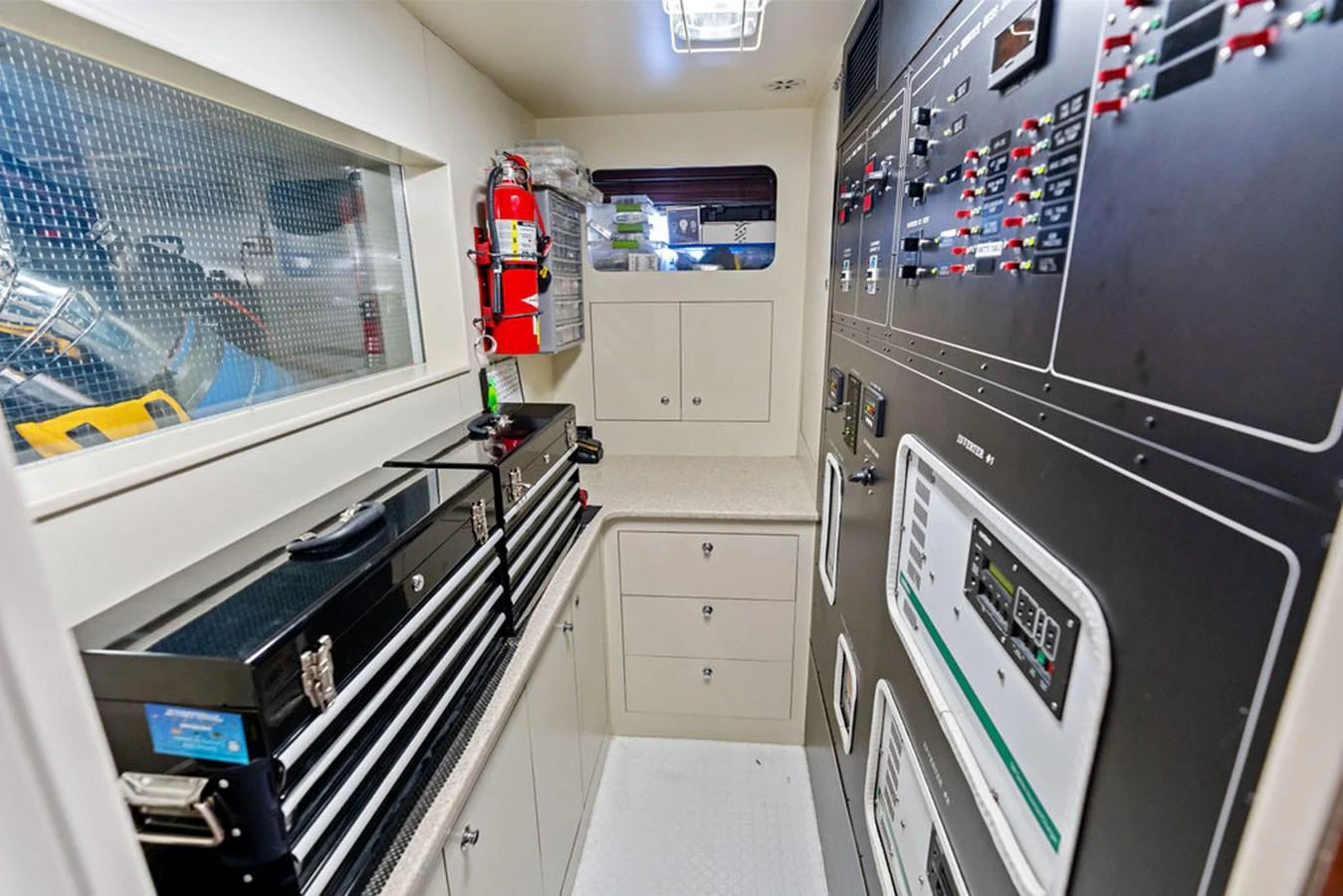 The yacht's engine room is equipped with advanced control panels and essential tools for maintenance. aboard BABE Yacht for Sale