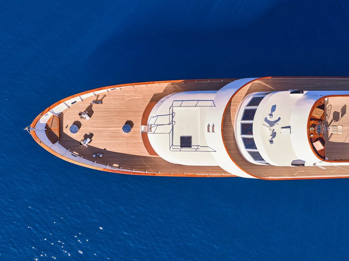 A stunning aerial view of a yacht showcasing its sleek design and spacious deck layout on a calm blue sea. aboard RESINA Yacht for Sale