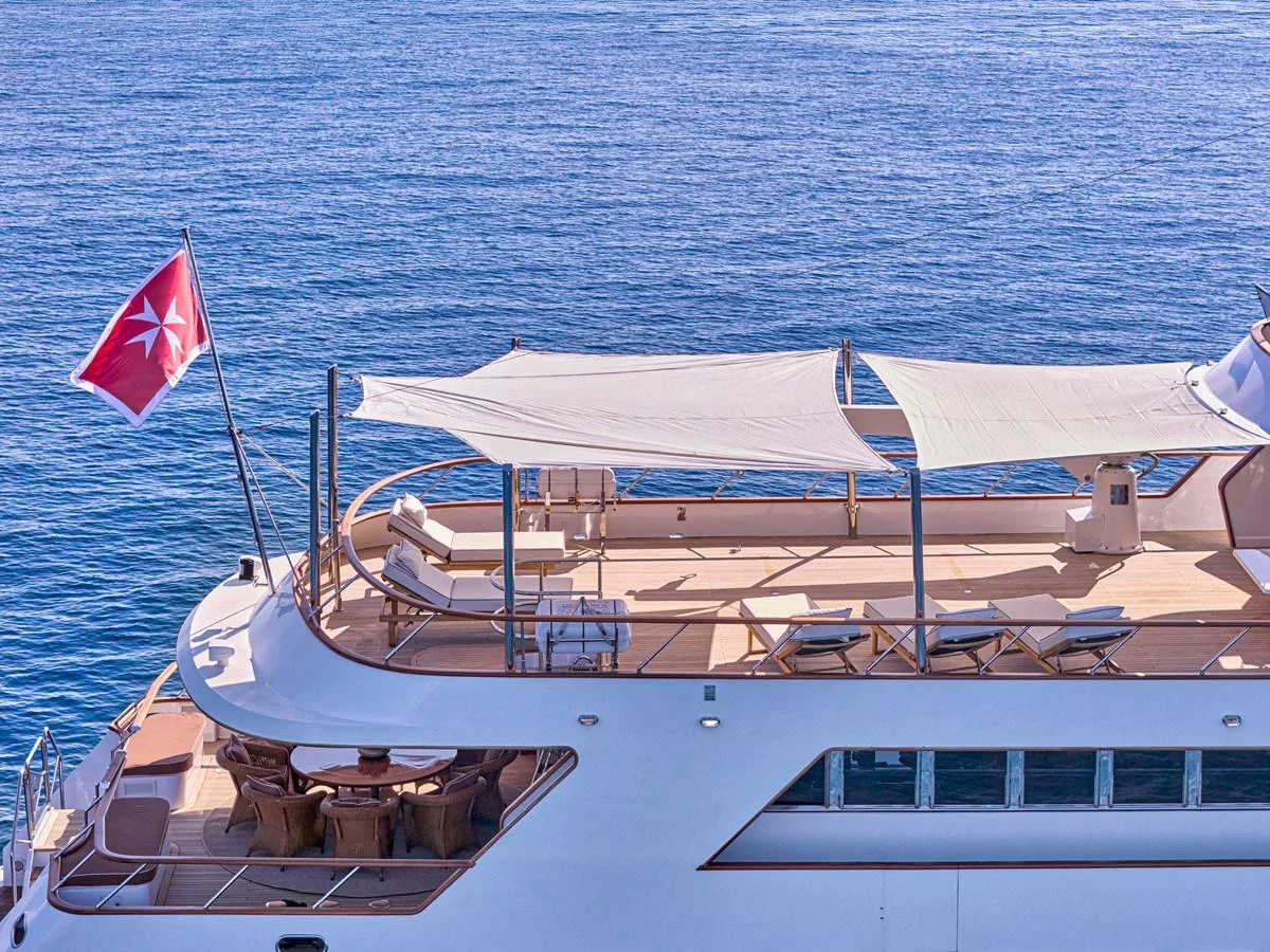 The yacht's sundeck offers a spacious and inviting area for relaxation and sunbathing. aboard RESINA Yacht for Sale