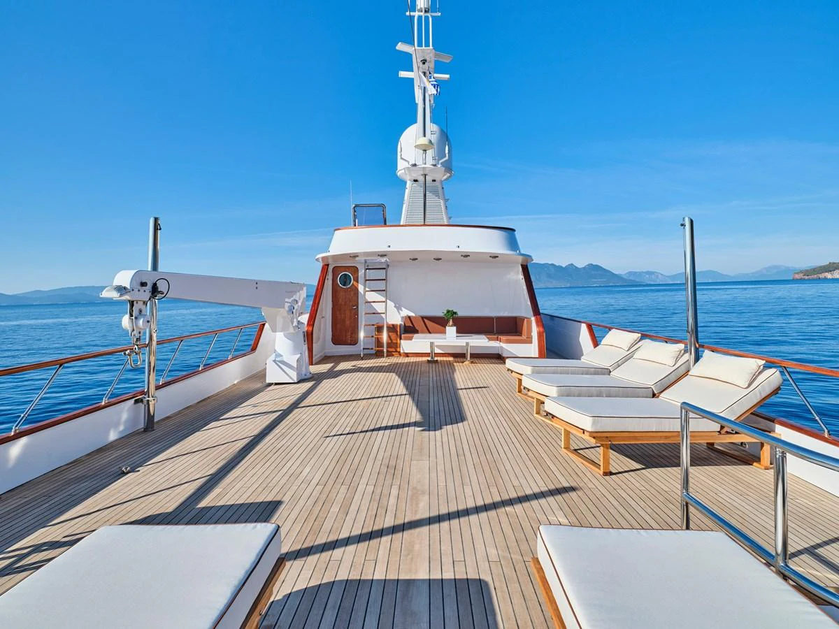 The sundeck offers ample lounging space with luxurious sunbeds and stunning ocean views. aboard RESINA Yacht for Sale