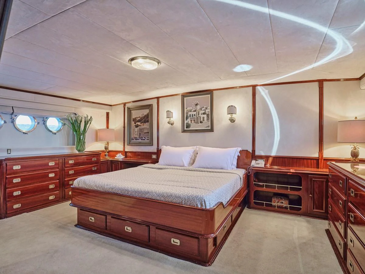 The master stateroom features a luxurious bed with ample storage and elegant decor. aboard RESINA Yacht for Sale