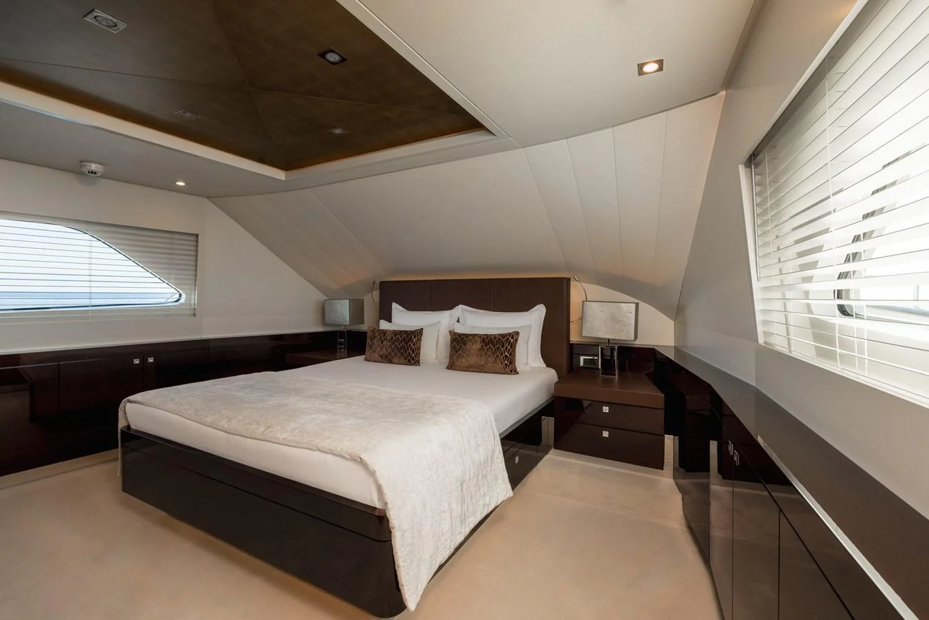 The stateroom features a luxurious bed with elegant decor and ample natural light. aboard ORIZZONTE Yacht for Sale
