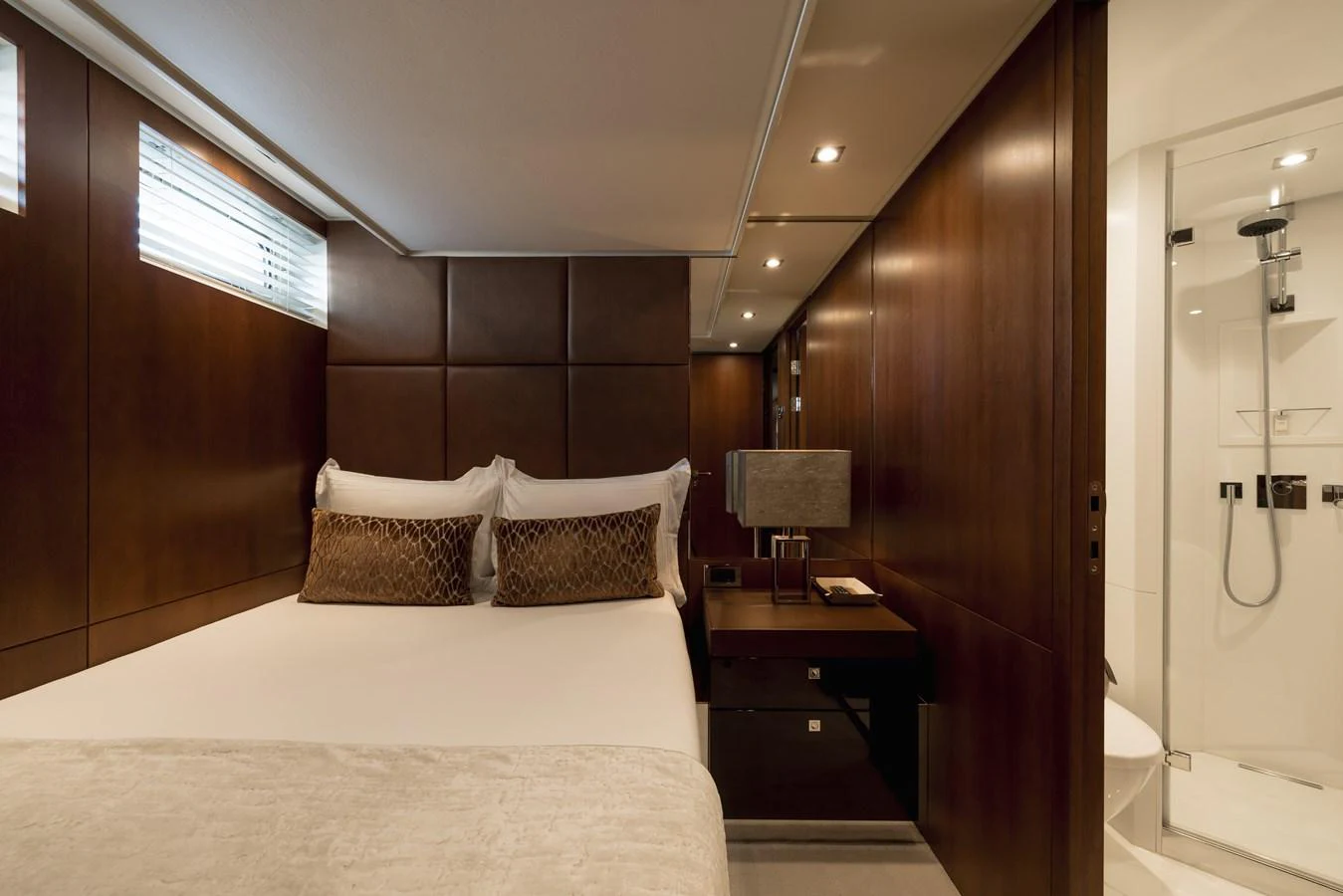 The stateroom features a luxurious bed with elegant bedding and a modern ensuite bathroom. aboard ORIZZONTE Yacht for Sale