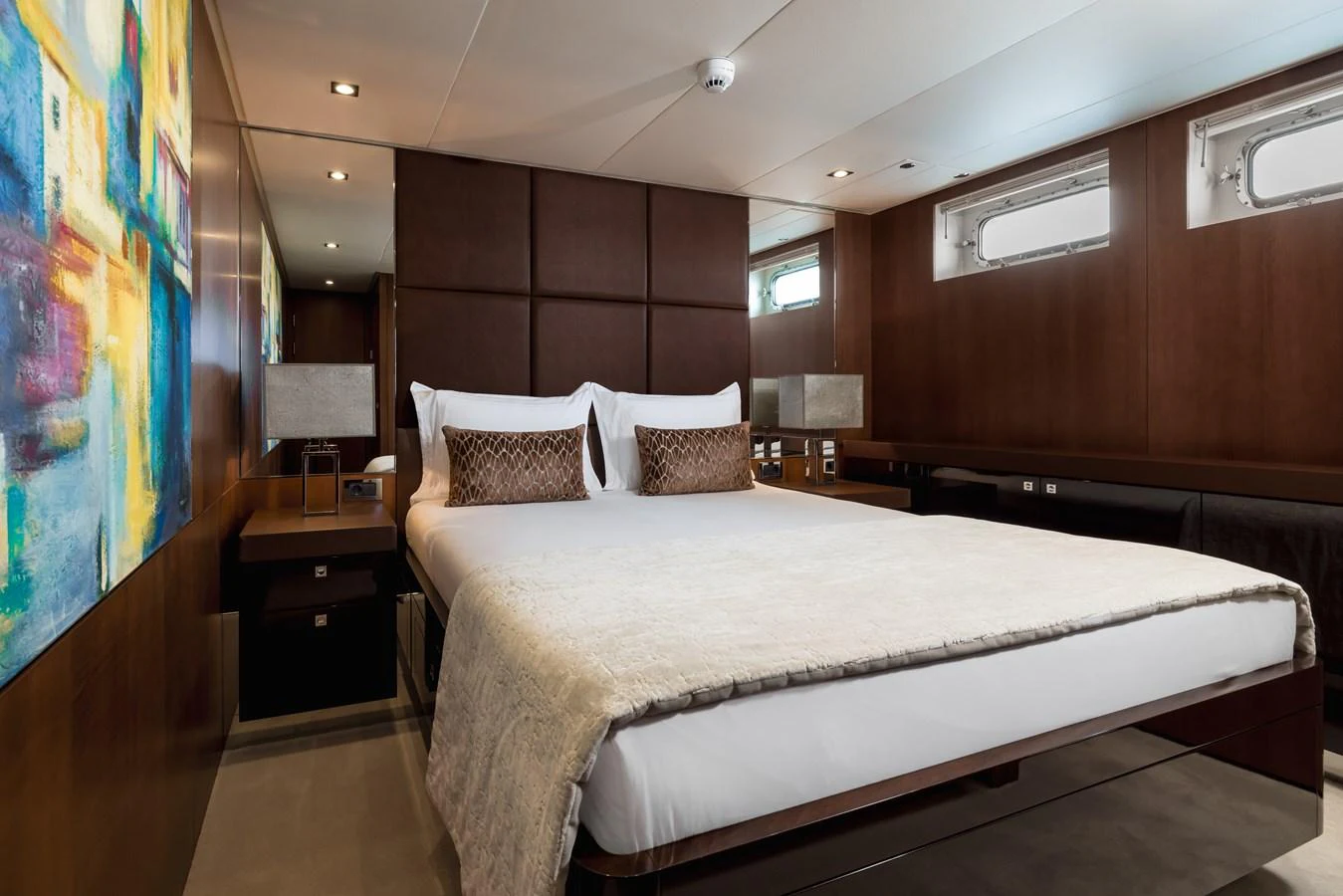 The stateroom features a luxurious bed with elegant decor and ample natural light. aboard ORIZZONTE Yacht for Sale