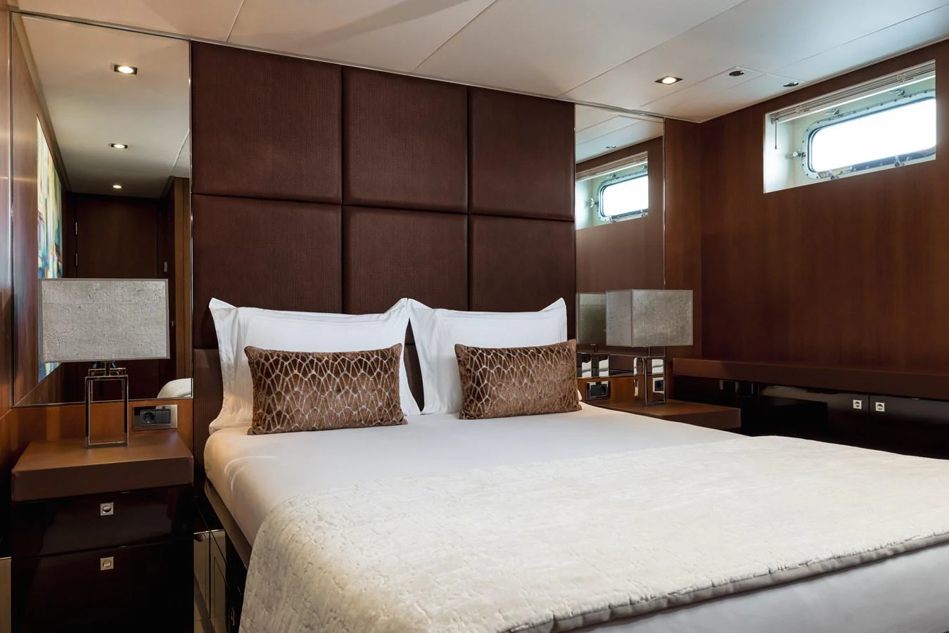 The stateroom features a luxurious bed with elegant bedding and modern decor. aboard ORIZZONTE Yacht for Sale