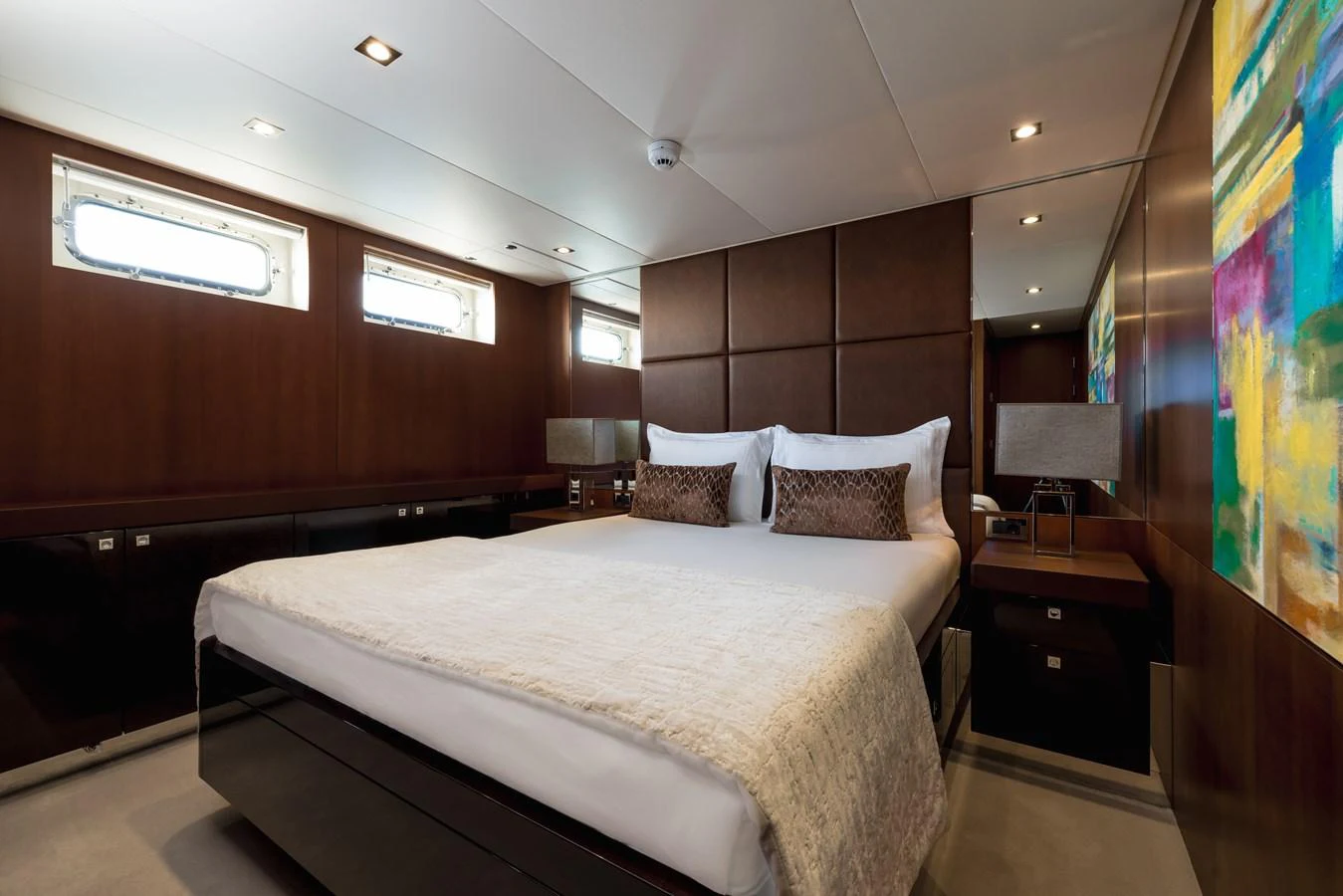 The master stateroom features a luxurious bed with elegant decor and ample natural light. aboard ORIZZONTE Yacht for Sale