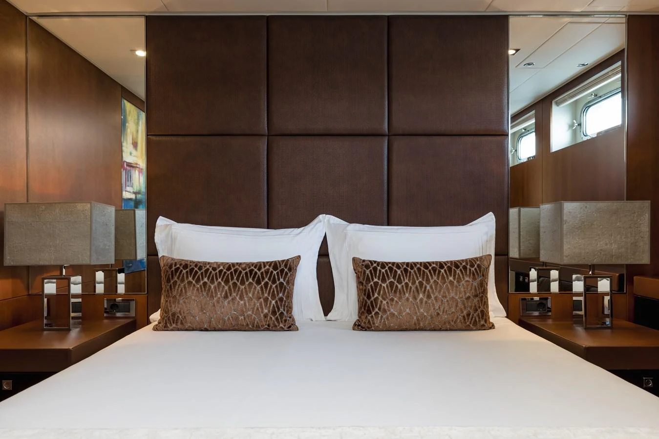 The master stateroom features a luxurious bed with elegant decor and ample natural light. aboard ORIZZONTE Yacht for Sale