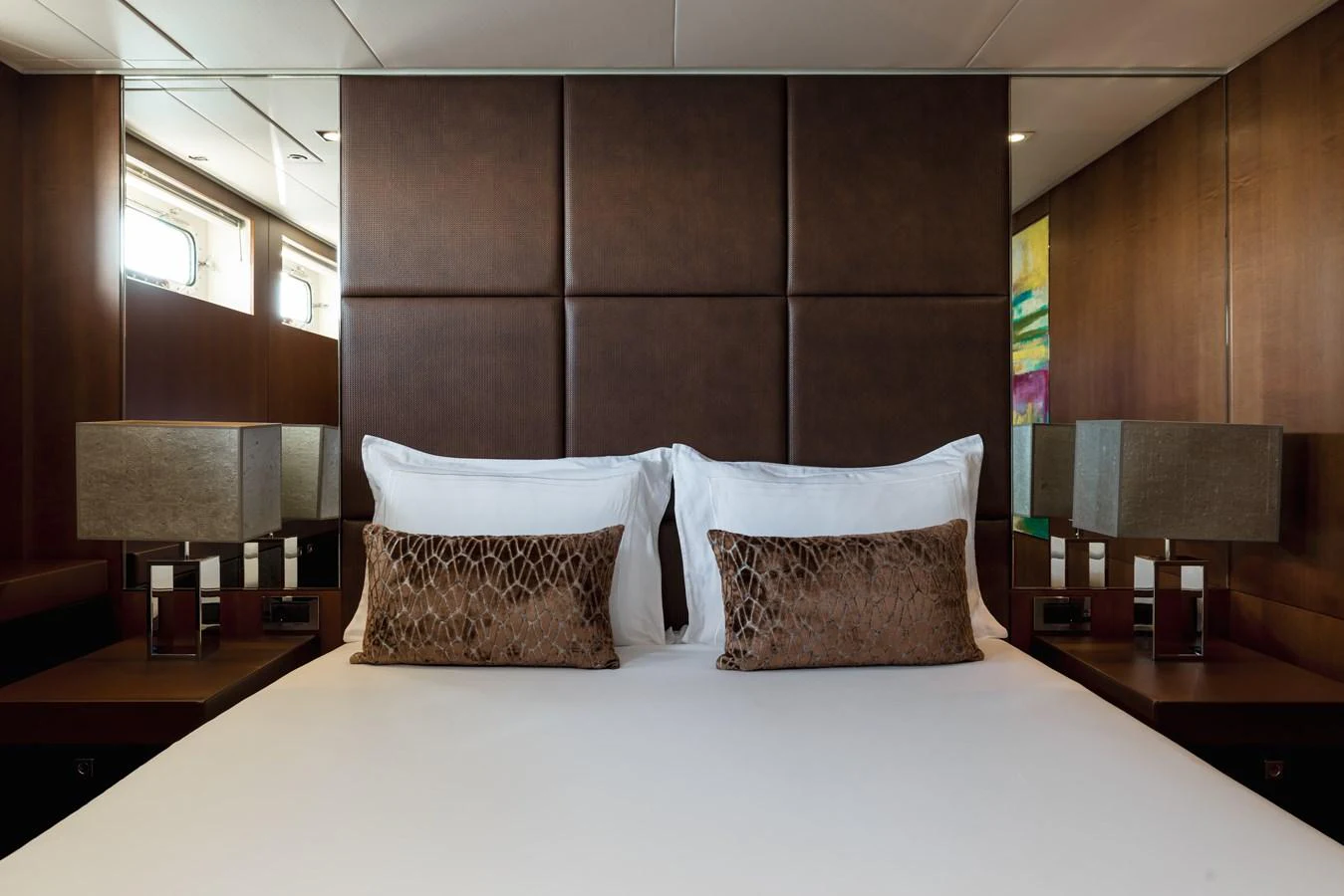 The stateroom features a luxurious bed with elegant decor and ample natural light. aboard ORIZZONTE Yacht for Sale
