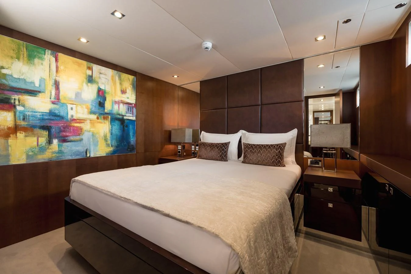 A luxurious stateroom featuring a large bed, modern decor, and ambient lighting. aboard ORIZZONTE Yacht for Sale