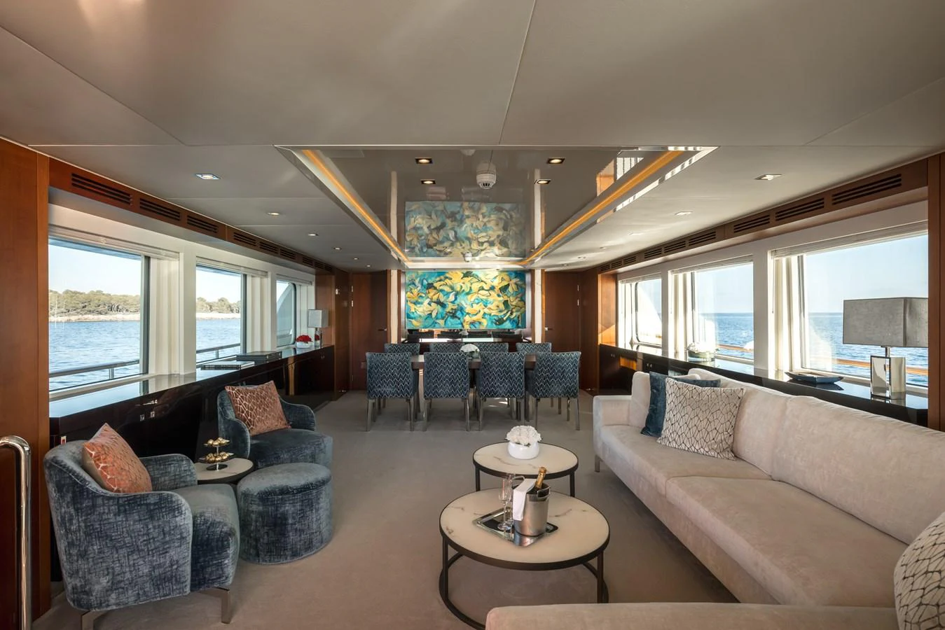 The salon offers a spacious and elegant setting with ample seating and large windows providing stunning sea views. aboard ORIZZONTE Yacht for Sale