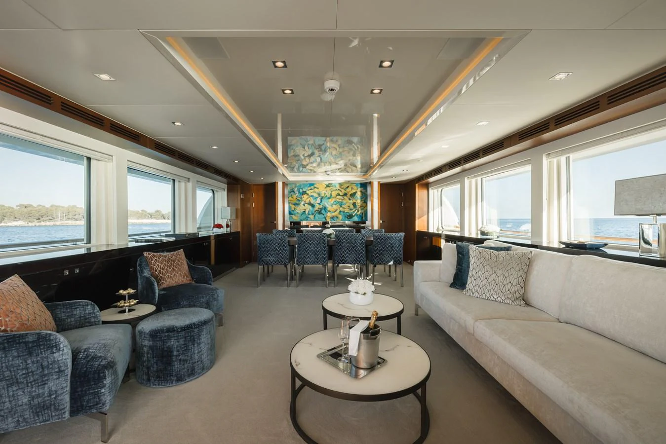 The salon features elegant seating with panoramic windows offering stunning sea views. aboard ORIZZONTE Yacht for Sale