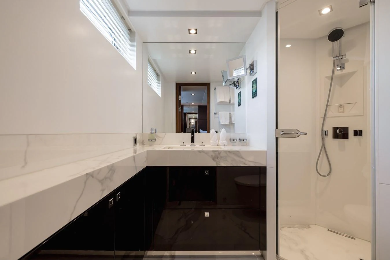 The yacht's bathroom features a sleek design with modern fixtures and a spacious shower area. aboard ORIZZONTE Yacht for Sale