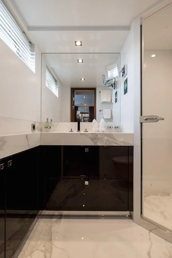 A modern bathroom with sleek finishes and a spacious shower area. aboard ORIZZONTE Yacht for Sale