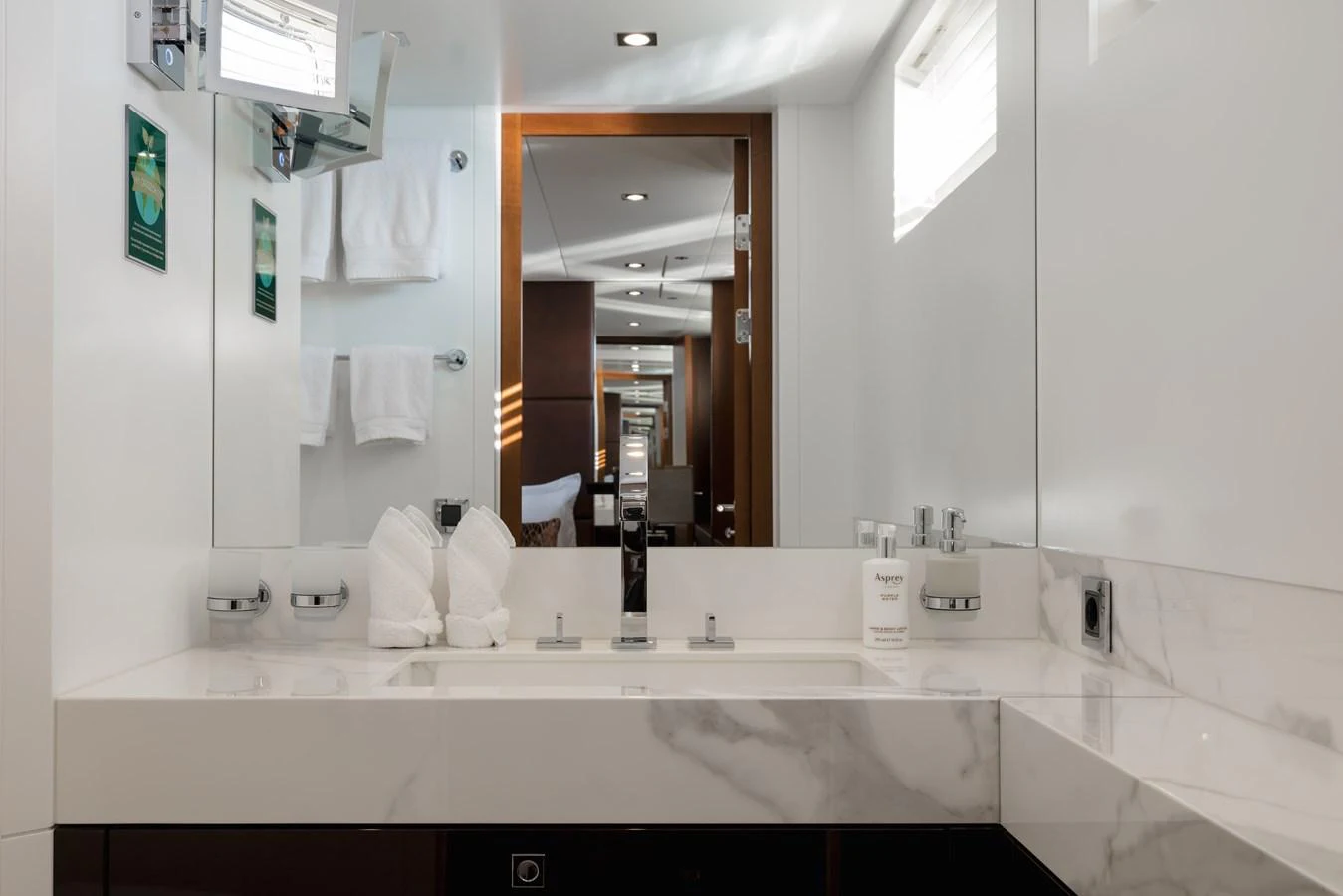 The yacht's bathroom features a sleek, modern design with a marble countertop and elegant fixtures. aboard ORIZZONTE Yacht for Sale