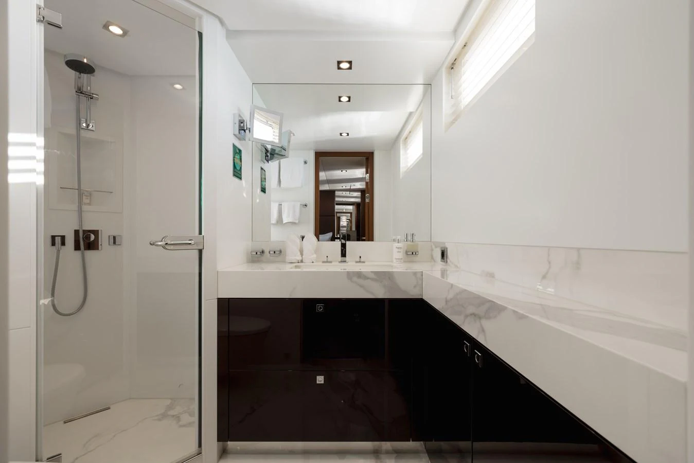 The yacht's bathroom features a modern design with sleek fixtures and ample lighting. aboard ORIZZONTE Yacht for Sale