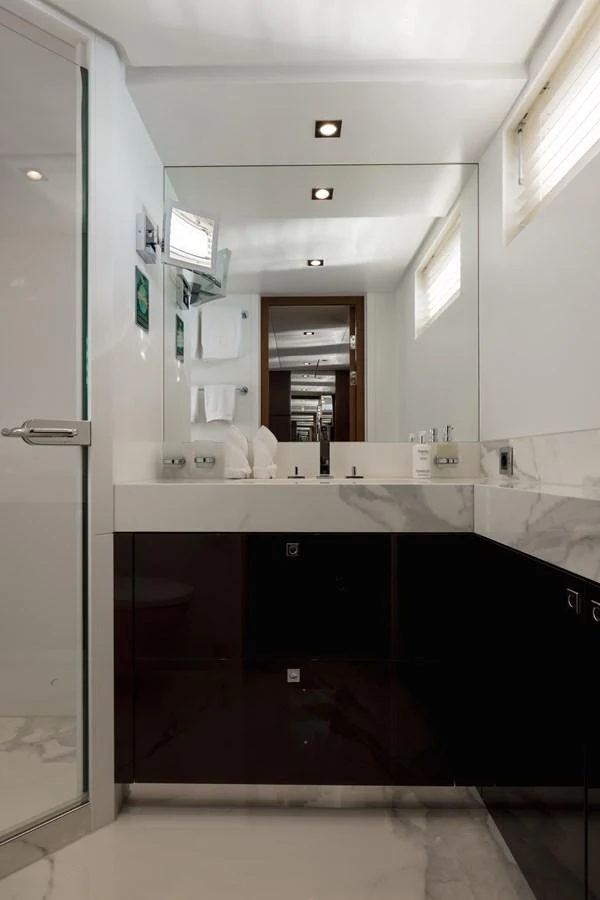 The yacht's bathroom features a sleek design with modern fixtures and a large mirror. aboard ORIZZONTE Yacht for Sale