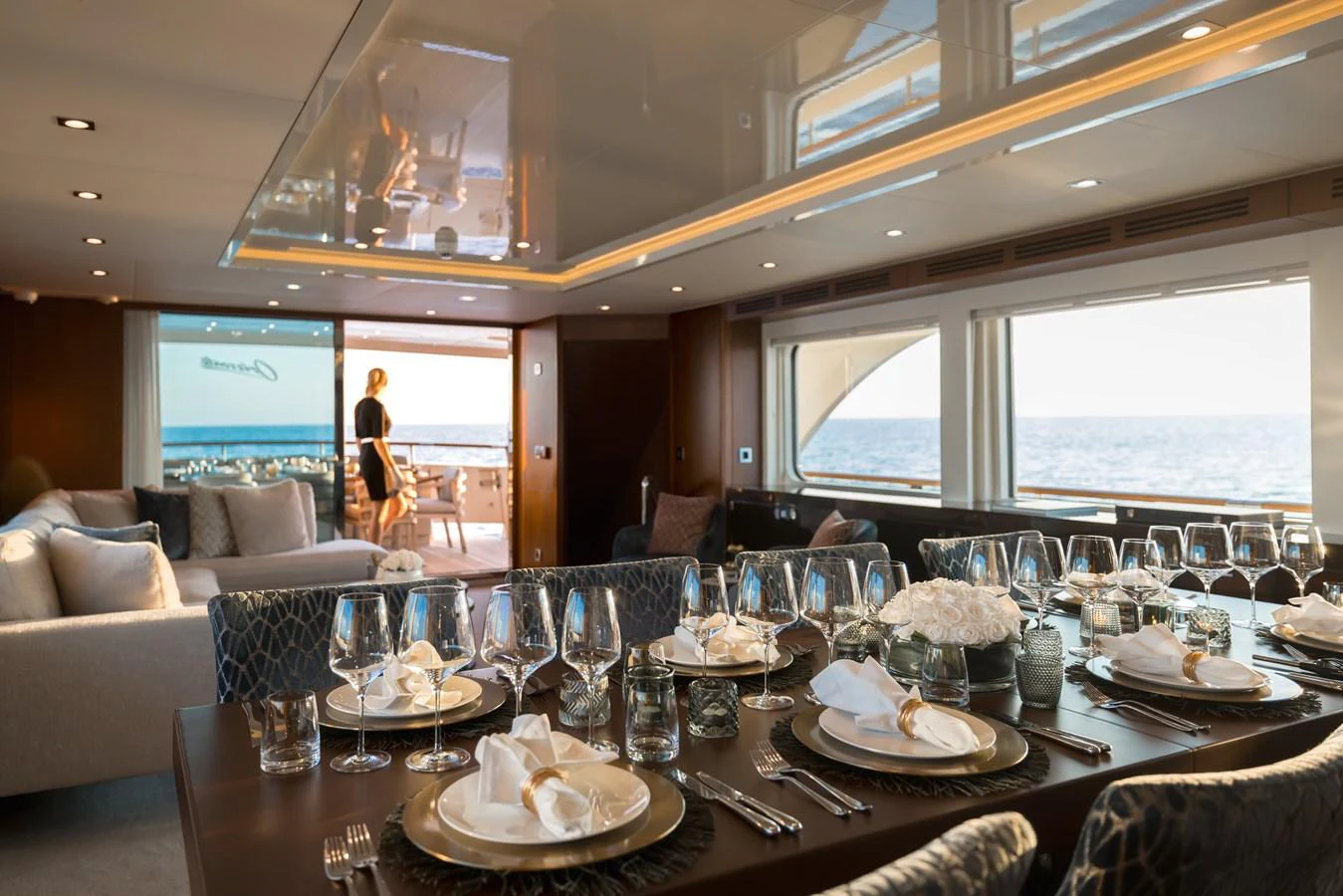 The yacht's elegant dining area offers a luxurious setting with a stunning ocean view. aboard ORIZZONTE Yacht for Sale