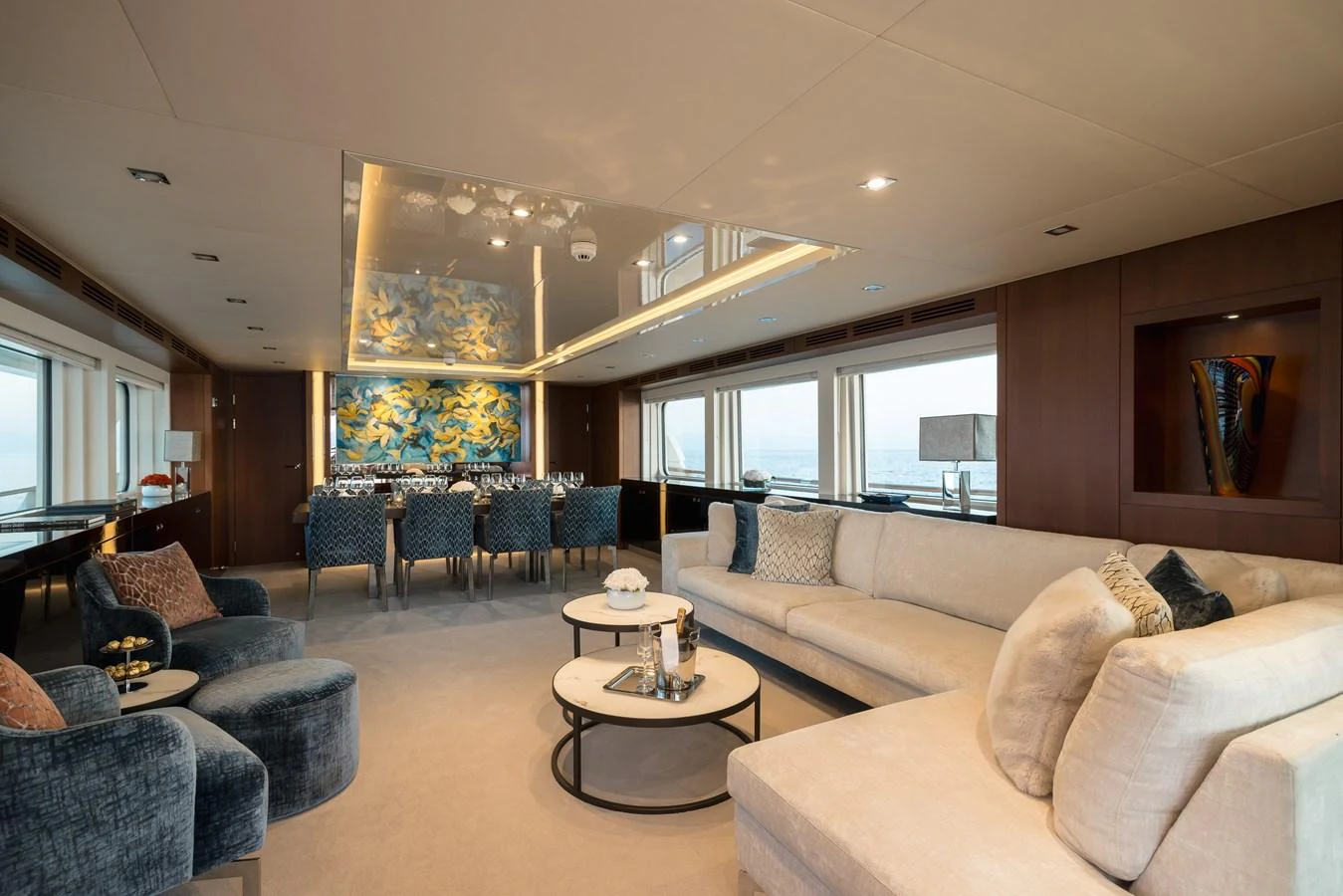 The yacht's salon features luxurious seating and elegant decor with panoramic windows offering stunning sea views. aboard ORIZZONTE Yacht for Sale