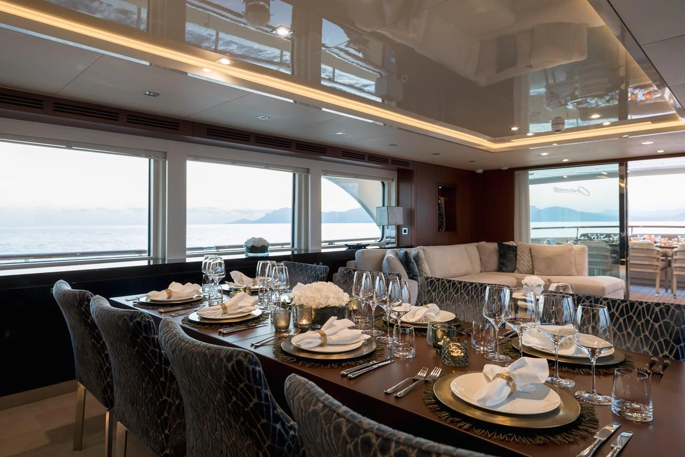 The yacht's dining area offers an elegant setting with panoramic views of the sea. aboard ORIZZONTE Yacht for Sale