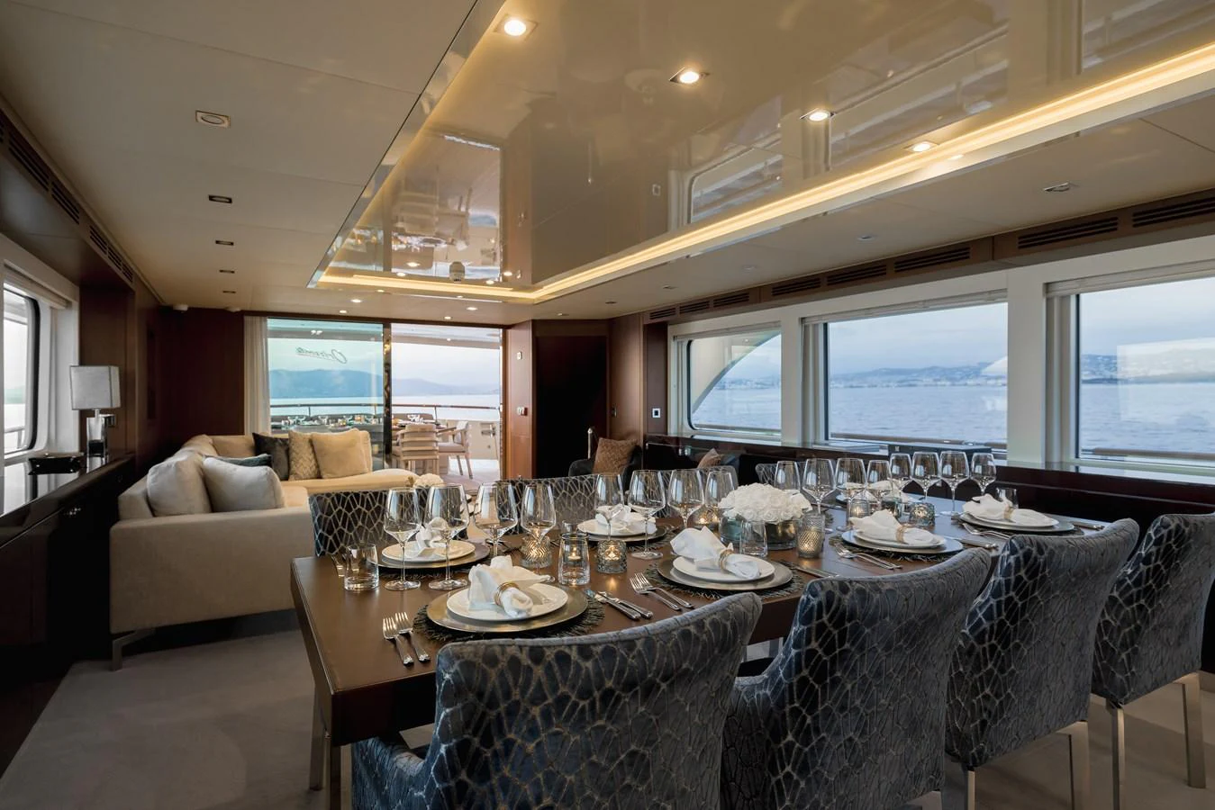 The yacht's dining area offers an elegant setting with panoramic views and luxurious furnishings. aboard ORIZZONTE Yacht for Sale
