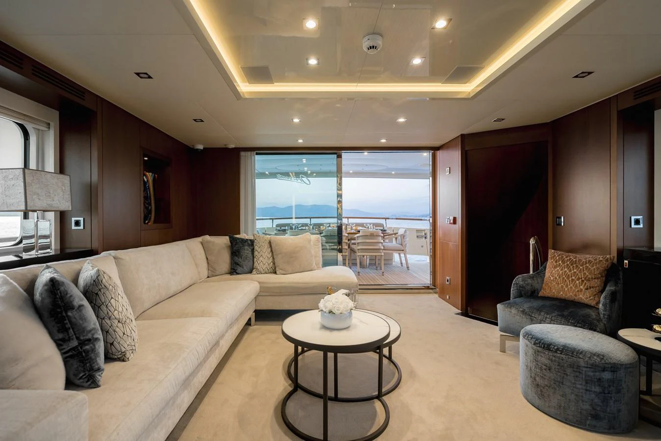 The yacht's salon features luxurious seating and elegant decor with a view of the aft deck. aboard ORIZZONTE Yacht for Sale