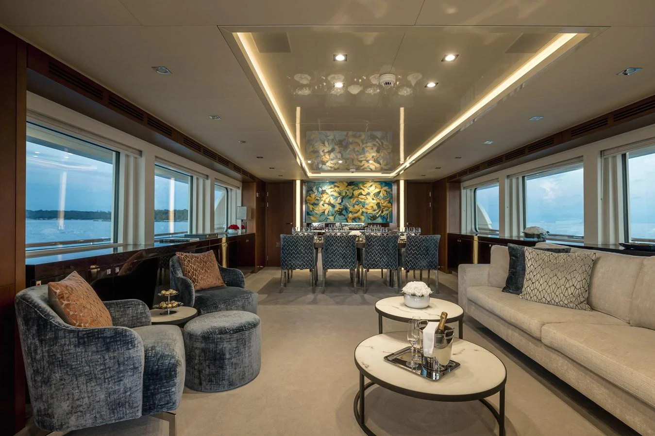 The luxurious salon features elegant seating and a sophisticated dining area with panoramic views. aboard ORIZZONTE Yacht for Sale